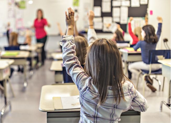 Girl raising hand in class